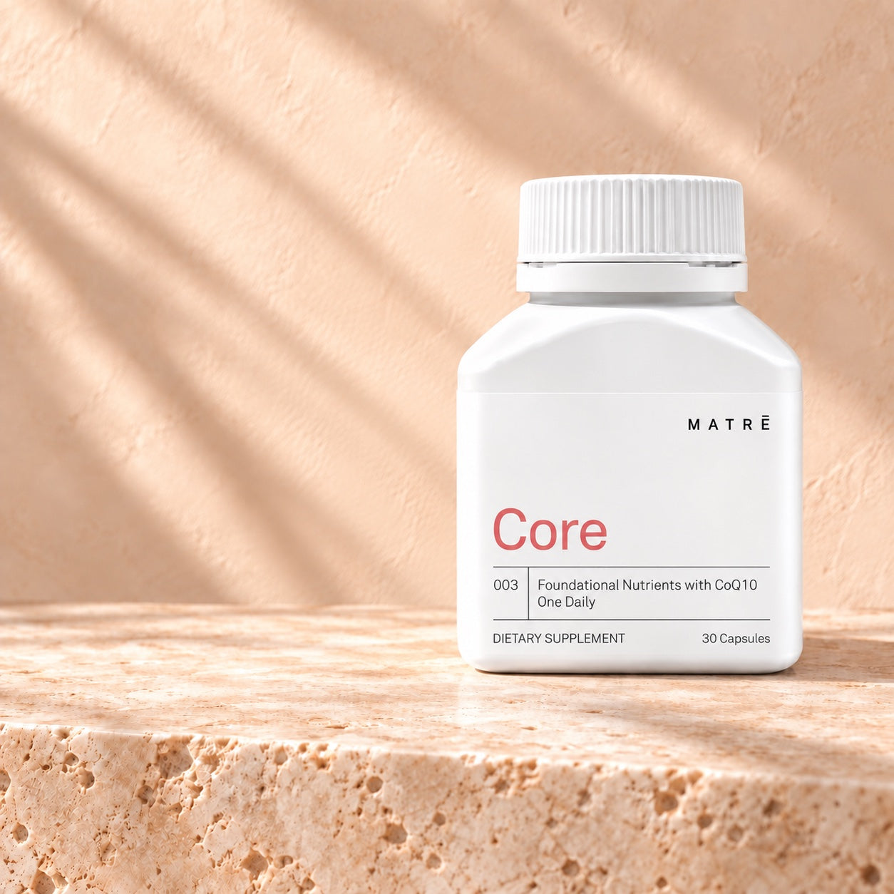 Matrē Core, 30 capsules, on pale stone in soft natural light